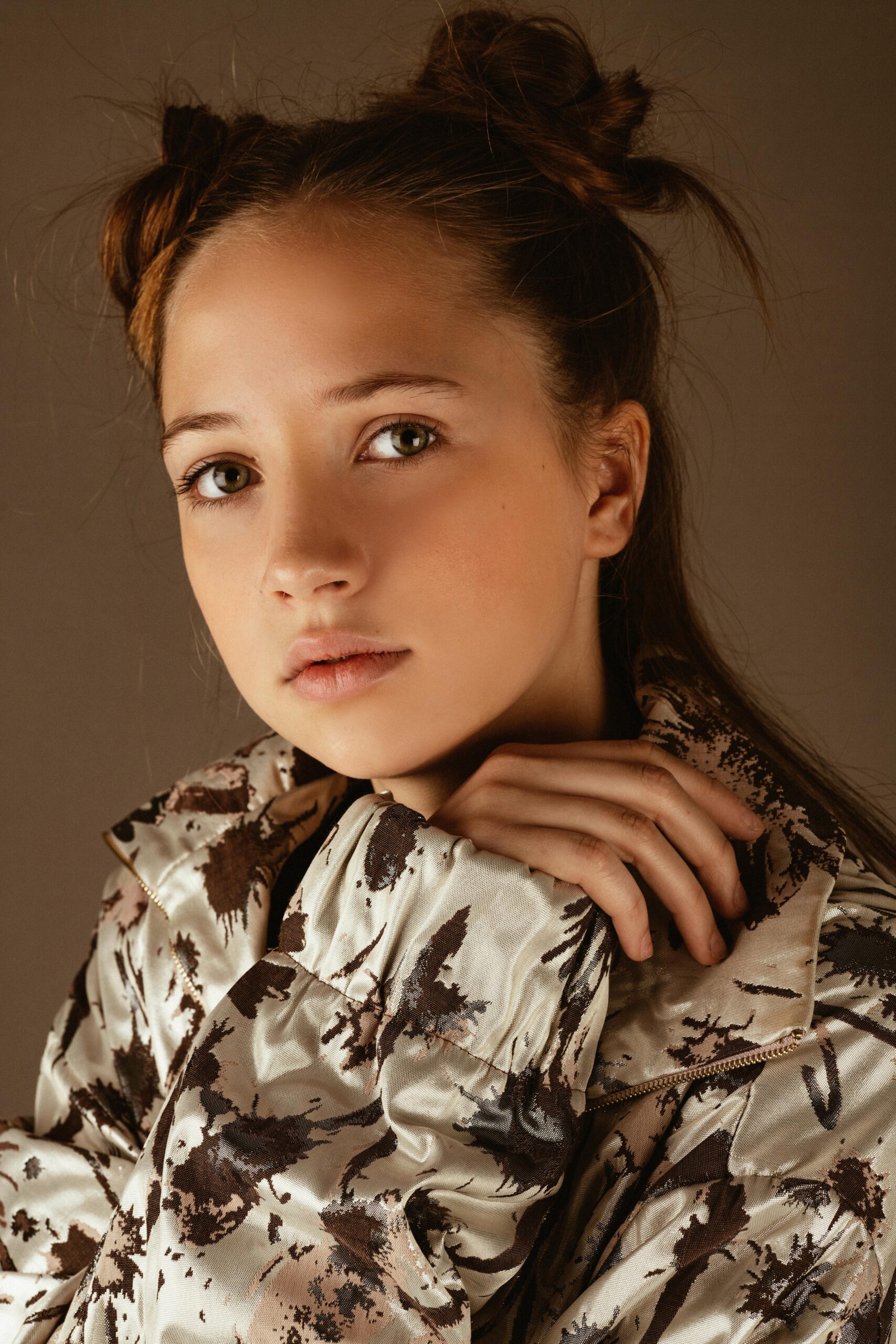Portrait of a fashionable young model posing with style in a studio setting.